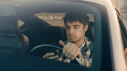 Disappointed stressed sad man Caucasian auto driver businessman inside automobile car waiting in...