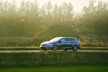 Large estate car on countryside asphalt road