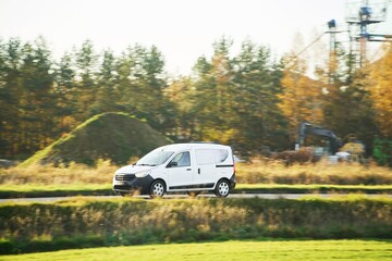 Fototapeta premium Commercial vehicle traveling on country road