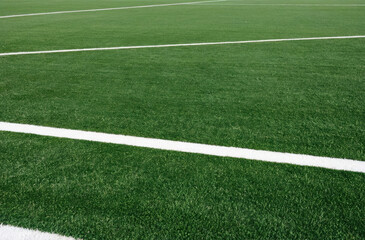 Obraz premium Macro photo of the green grass of the sports field, highlighting the texture and details, giving the impression of being close to nature.