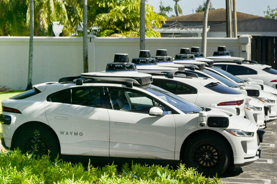 Miami, Florida, USA - 4 December 2023: Waymo autonomous driving vehicles parked in a row. The cars are use as self-hail taxis.