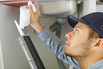 a male worker is using silicone