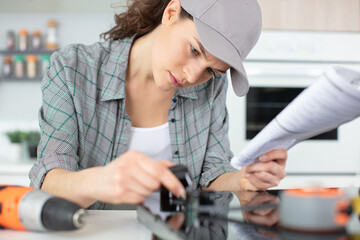 woman installing induction hobs in a kitchen