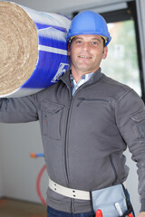 isolated worker is carrying insulation roll
