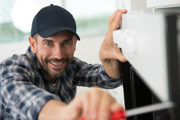 portrait of man fitting new oven