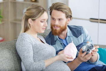 a young couple holding baby cloths