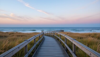 Fototapeta premium A peaceful wooden boardwalk leading through lush coastal dunes to the ocean, with a stunning sunset sky. Perfect for travel, relaxation, and nature themes.