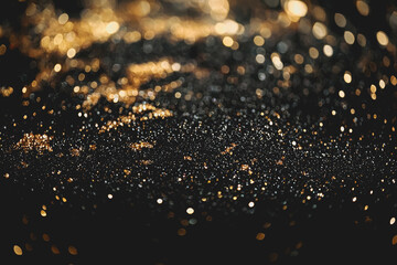 Black background with shimmering gold glitter texture for backgrounds or design projects