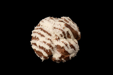 Profiteroles with coconut cream on a black background.