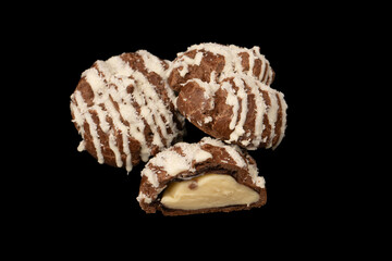 Profiteroles with coconut cream on a black background.