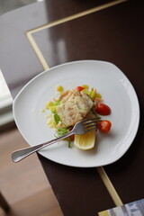 Gourmet Fish Dish with Tomatoes and Lemon
