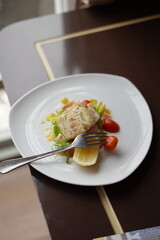 Elegant Fish Dish with Salad and Tomatoes