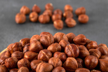 Close-up of hazelnut kernels on gray background