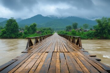 Wet wooden bridge leading to remote village in the mountains during rainy season