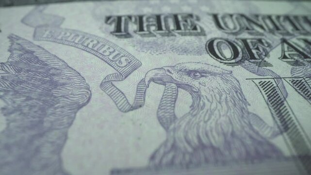 Creative 4k video of five american dollar banknote moving details with a close-up portrait of Abraham Lincoln and the effect of his glowing eyes. USA fiat money. Slow motion.