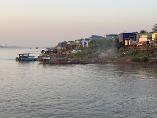 Boats moored at the banks of the Mekong river near the city of Phnom Penh in Cambodia