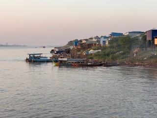 Fototapeta premium Boats moored at the banks of the Mekong river near the city of Phnom Penh in Cambodia