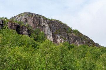 Rocky mountain against the blue sky in summer time. Rybachy peninsula near Murmansk, Russia