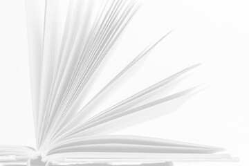 Open book with turning pages showcasing the elegance of literature and storytelling in a minimalistic setting