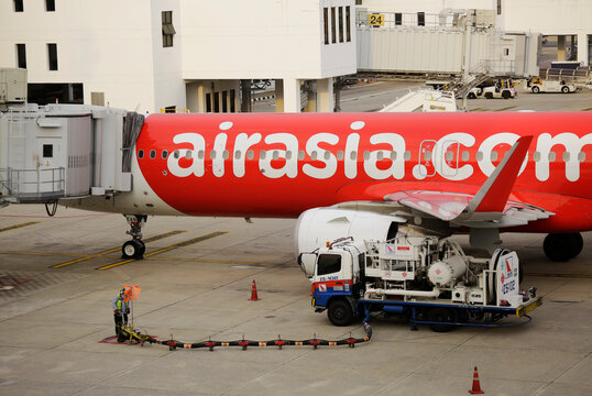 Bangkok, Thailand - June 29, 2023: Aircraft of the low cost airline AirAsia is seen parked at the gate prior to departure in Don Mueang international airport (DMK).