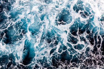 Ocean water texture. Top view of amazing water with foam. Can be used in covers, packaging, posters, textures, cards, art, and design projects. Creative nature background image.