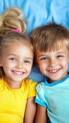 Children smiling, lying on a blue bed, happiness, childhood