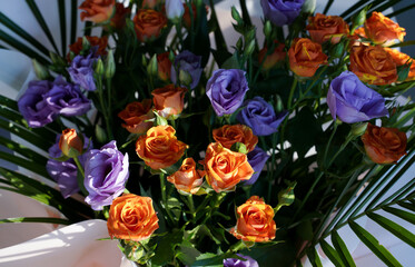 Colorful bouquet of mixed flowers. Allium Flowers in orange and purple tones. Floral shop concept . Flowers delivery.          
