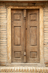 Ancient Uzbek architecture with carved wooden door in Khiva , Uzbekistan