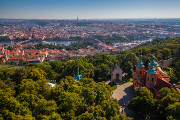 A panoramic cityscape view from a high vantage point, showcasing a sprawling city with red-roofed...
