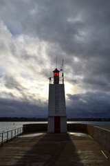 A lighthouse in Saint-Malo, Brittany, stands against an apocalyptic sky as the sun hides behind...