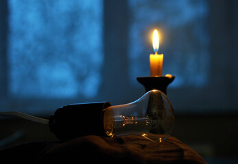 In the absence of electricity supply, a candle is lit