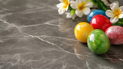 Colorful Easter eggs and flowers on a marble surface, symbolizing spring celebrations.