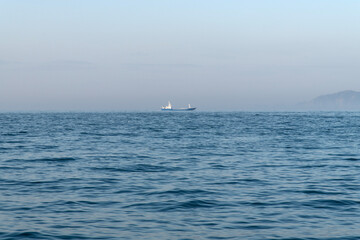 passenger boat in the fog on the sea at dawn
