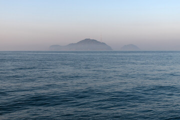 sea and island with fog at dawn