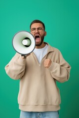 A man is holding a megaphone and yelling. He is wearing glasses and a white shirt