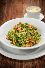 spaghetti in pesto sauce with walnuts