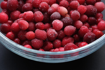 Frozen cranberries in a glass bowl. Close up.