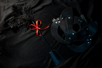 Sexy set of whip and cat mask on black background