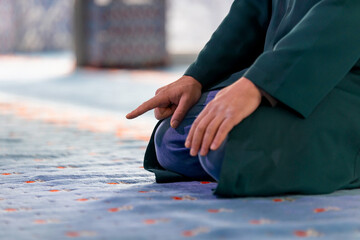 A captivating image of an imam praying after praying and reciting the Quran in a tranquil mosque, capturing the essence of faith and devotion.