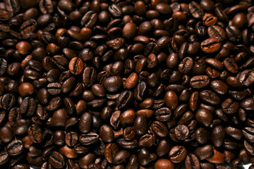 Aromatic roasted coffee beans textured background.