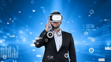 Project manager wearing VR headset while analyzing at financial statistic. Business man wearing virtual reality goggle while checking and looking at statistic chart. Technology innovation. Apparatus.