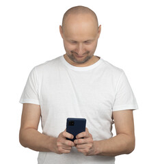 Focused man in white t-shirt looking at smartphone screen