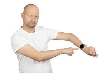 Man in a white t-shirt pointing at his wristwatch with a serious expression