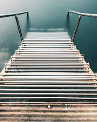 Ladder leading into the tranquil sea in Sweden showcasing serene coastal beauty during calm waters