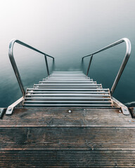 Ladder leading into the tranquil sea in Sweden showcasing serene coastal beauty during calm waters