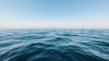Fototapeta premium Calm ocean waves under a clear blue sky; serene seascape for travel websites