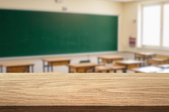 Wooden top with blurred empty classroom background can be used for mocking up or display product to make advertising.