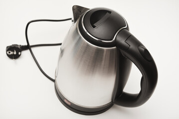 Electric kettle on a white background. A metal teapot with a black handle.
