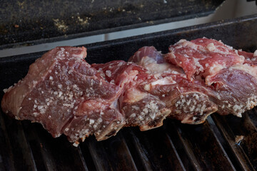 BBQ beef roasting on a metal grill