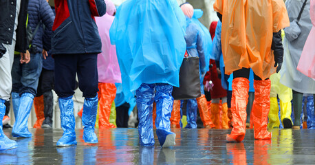 many tourists with waterproof gaiters to protect their footwear during high tide on the island of...